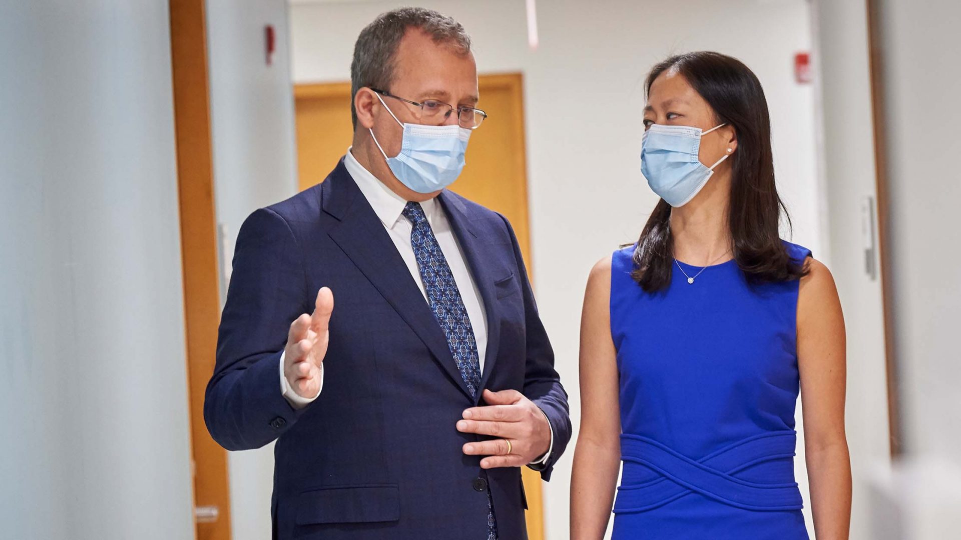 Dr. Feza Remzi and Dr. Shannon Chang Wearing Face Masks and Chatting in Hallway