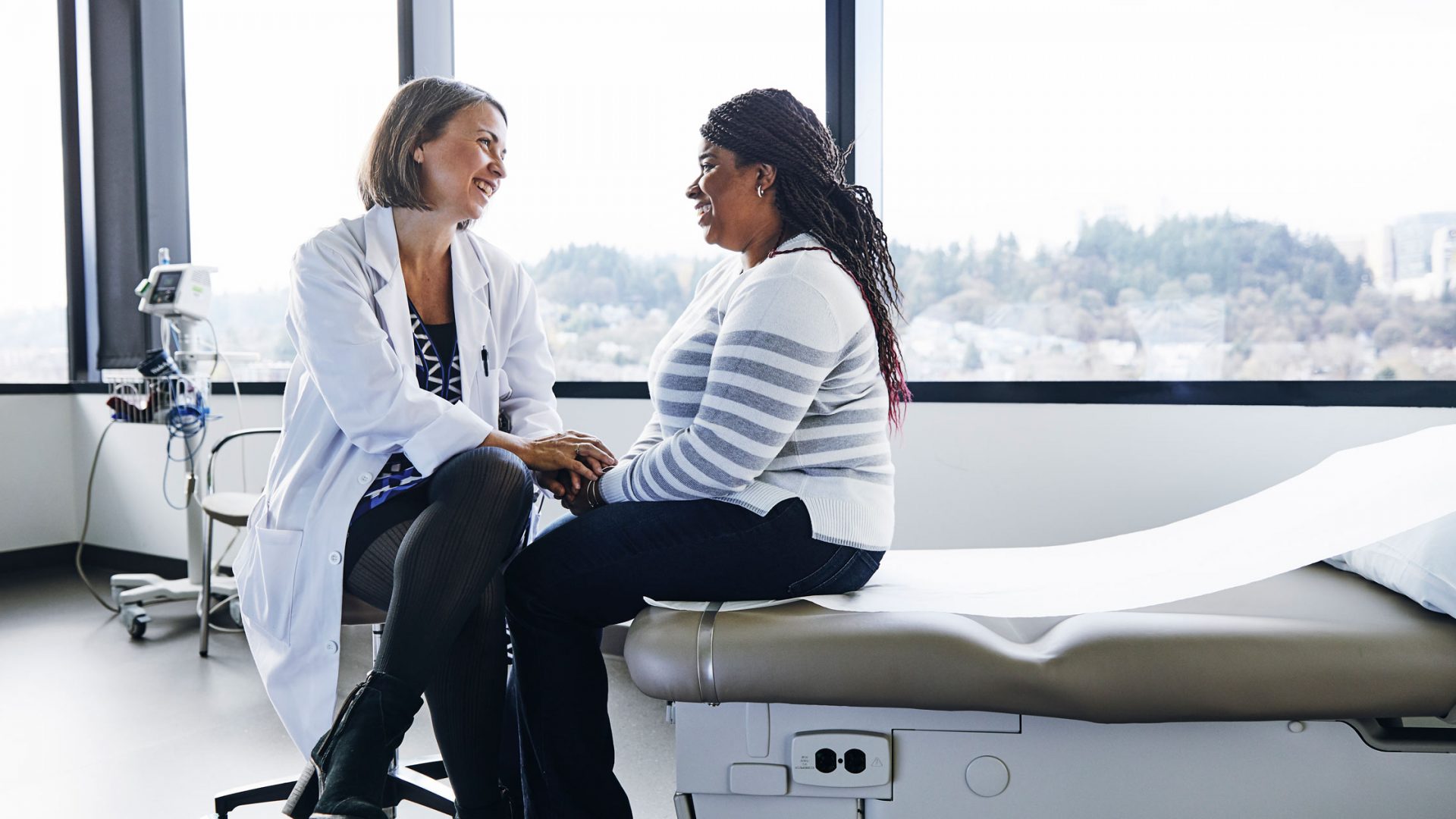 Physician Sits with Patient