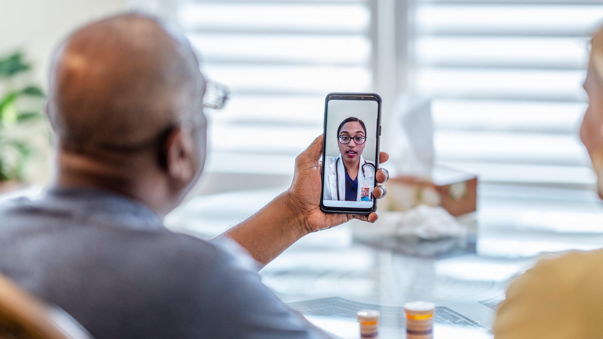 Person Having Video Appointment with Doctor via Mobile Phone
