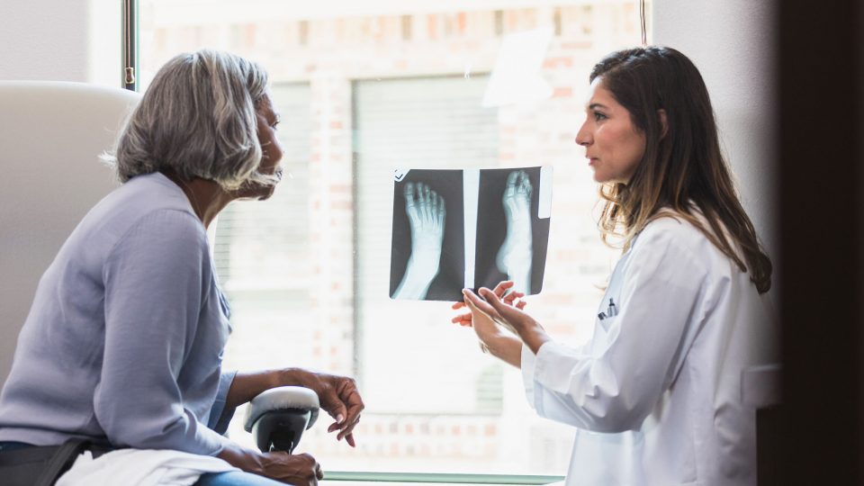 Doctor Reviews Foot and Ankle X-Rays with Patient