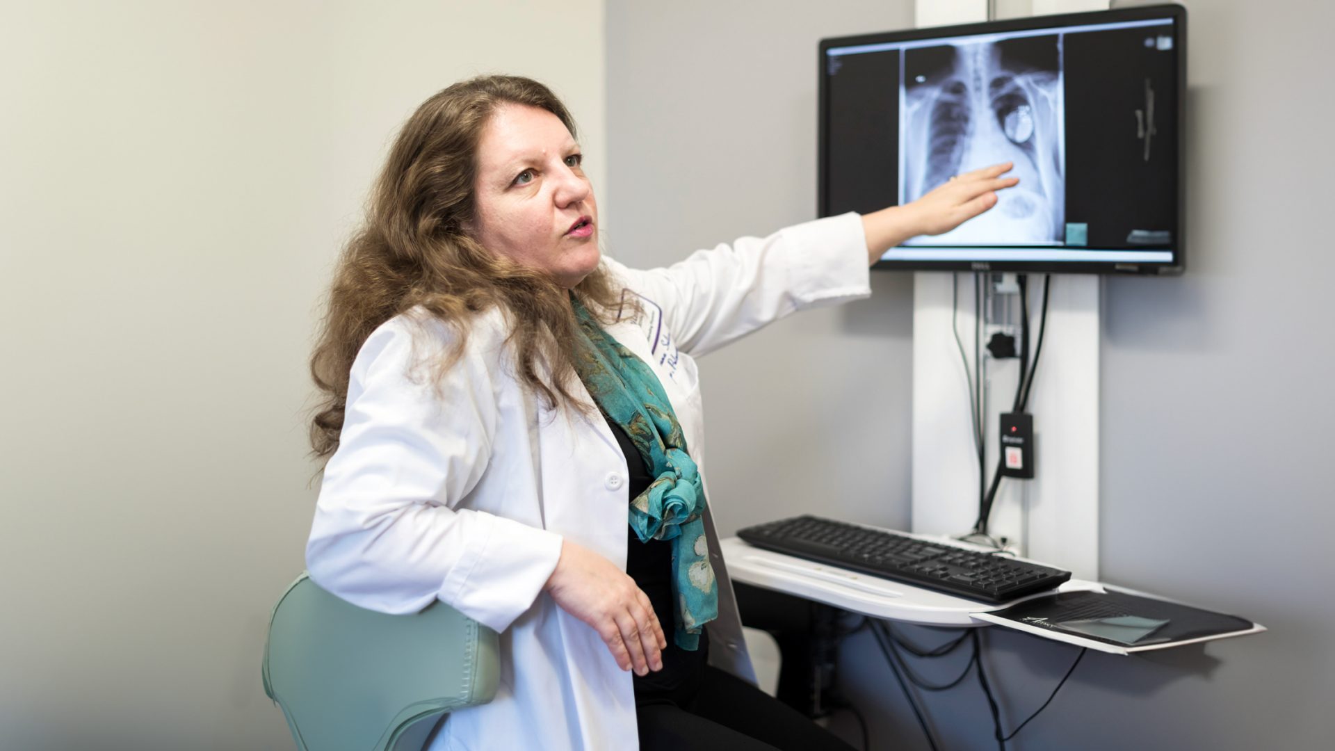 Dr. Roxana Sulica Pointing to Chest Imaging on Computer Screen and Talking to Someone Outside of the Image