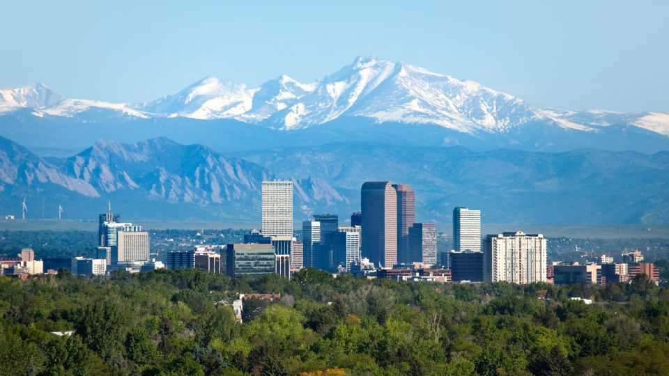 View of Denver skyline and Rocky Mountains on a sunny day
