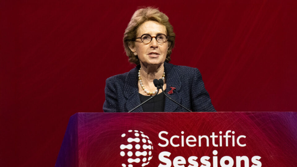 Dr. Judith Hochman speaks behind a podium that says Scientific Sessions